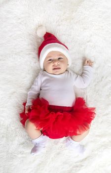 Baby dressed as Santa Claus. Christmas. Selective focus. People.