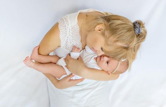 Mom is holding a newborn baby. Selective focus. People.