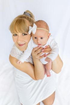 Mom is holding a newborn baby. Selective focus. People.