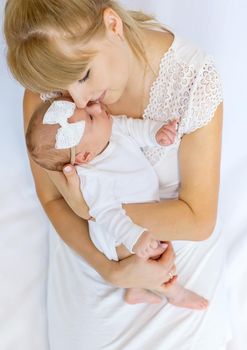 Mom is holding a newborn baby. Selective focus. People.