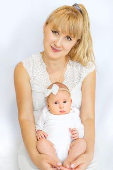 Mom is holding a newborn baby. Selective focus. People.