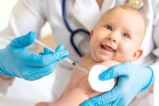 Vaccination baby, injection in the arm. Selective focus. People.