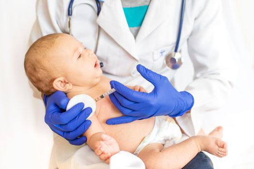 Vaccination baby, injection in the arm. Selective focus. People.