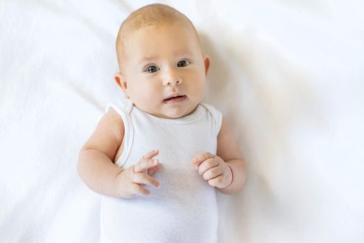 Baby was scared on a white background. Selective focus. People.