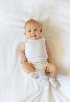 Baby smiles on a white background. Selective focus. People.