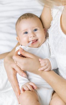 Mother gives medicine to baby for colic. Selective focus. People.
