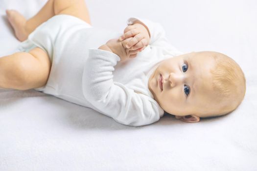 Little baby on a light background. Selective focus. People.
