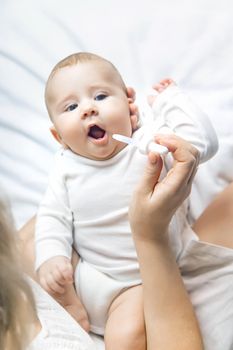 Mother gives medicine to baby for colic. Selective focus. People.