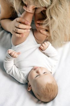 Mother with baby on a light background. Selective focus. People.