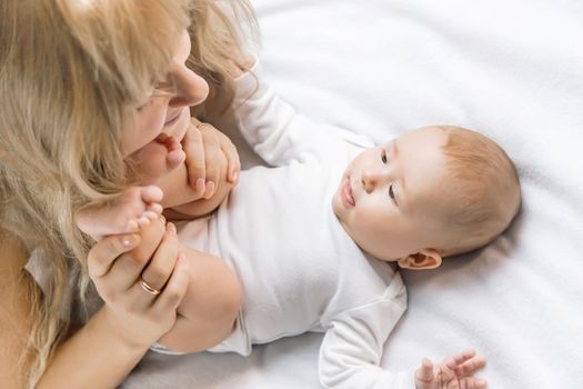 Mother with baby on a light background. Selective focus. People.