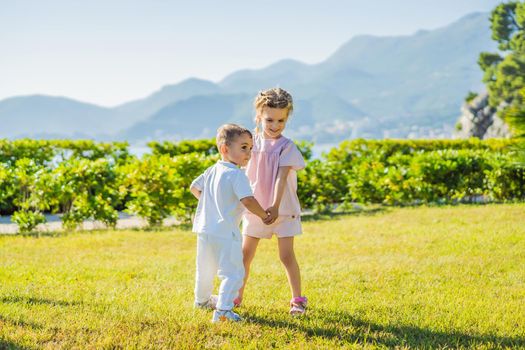 Portrait of two cute adorable baby children toddlers hugging and kissing each other, love friendship in childhood concept, best friends forever.