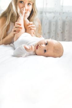 Mother with baby on a light background. Selective focus. People.