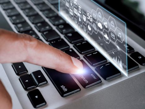 Close up hand man touch enter on laptop keyboard with hologram screen connect social media and social network 5G. Technology lifestyle concept. Man hand use laptop connect internet