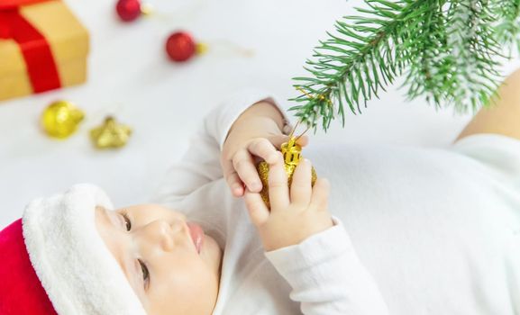 Christmas photo of baby with New Year's decor. selective focus. holiday.