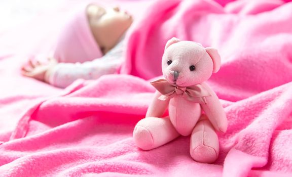 Baby sleeps with a bear. Selective focus. people.