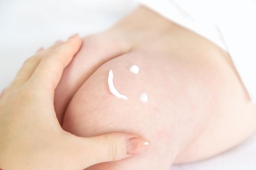 Smile sign on the baby's buttock with a cream. Selective focus. kid.