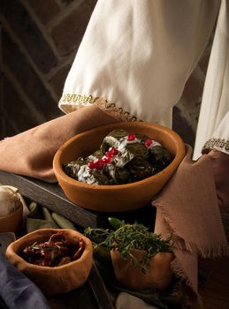 A close up shot of a dolma covered in grape leaves