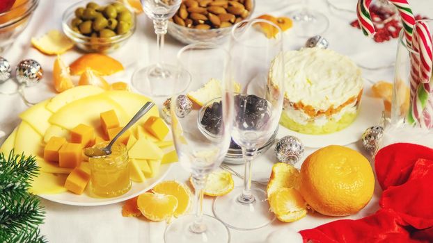 Christmas table with champagne and food. Selective focus. Holiday.