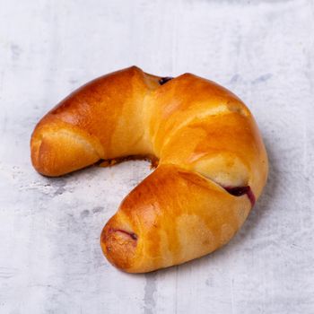 A close up shot of a bagel on a white surface