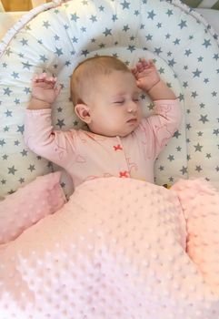 Baby sleeps on a pink bed. Selective focus. people.