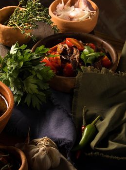 A vertical shot of a chef serving a gourmet salad dish