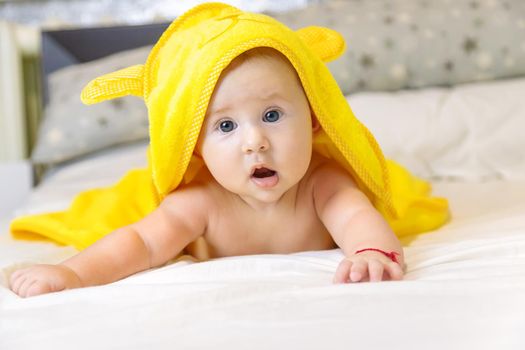 Little baby in a towel after bathing. Selective focus. People.