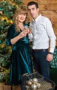 Christmas man and woman with glasses of champagne. Selective focus. Holiday.