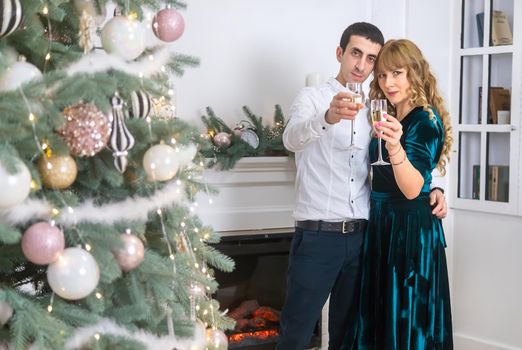 Christmas man and woman with glasses of champagne. Selective focus. Holiday.