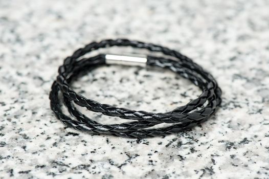 closeup black braided leather bracelet for men, casual style of men accessories.