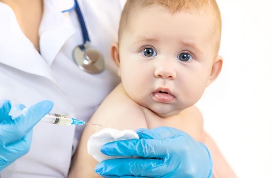 Vaccination of a baby by a doctor in a hospital. Selective focus. medicine.