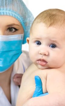 The baby is examined by a pediatrician at the hospital. Selective focus. people.