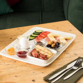 A closeup shot of a breakfast white plate on a wooden table