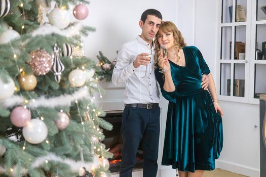 Christmas man and woman with glasses of champagne. Selective focus. Holiday.