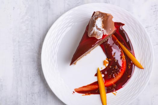 A closeup shot of a slice of chocolate cake on a white plate