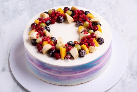 A top view shot of a fruit cake on a white plate