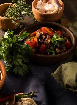 A vertical shot of a chef serving a gourmet salad dish