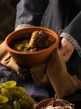 A vertical shot of a chef serving a gourmet dish