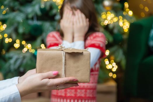 Child girl parents give presents for christmas. Selective focus. Holiday.