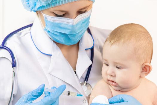 Vaccination of a baby by a doctor in a hospital. Selective focus. medicine.