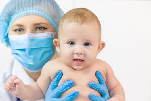 The baby is examined by a pediatrician at the hospital. Selective focus. people.