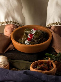 A close up shot of a dolma covered in grape leaves