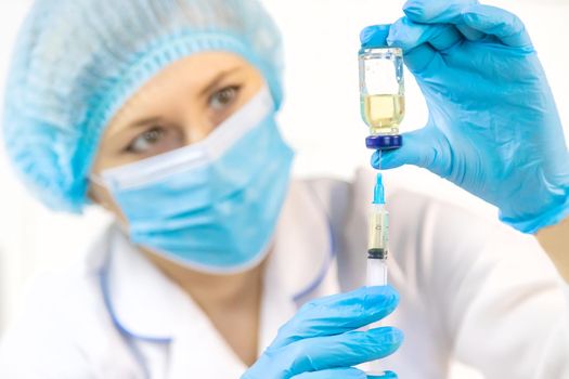 Doctor filling syringe with medication, closeup. Vaccination and immunization. Selective focus. Vaccine.