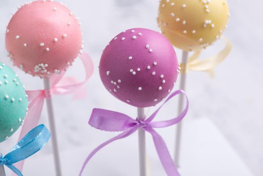 Colorful cake pops on a blurred background