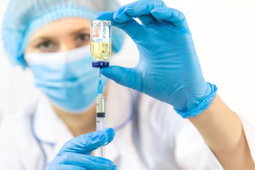 Doctor filling syringe with medication, closeup. Vaccination and immunization. Selective focus. Vaccine.