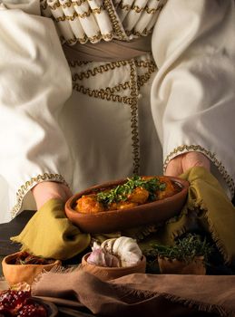 A waitress presenting a chicken stew