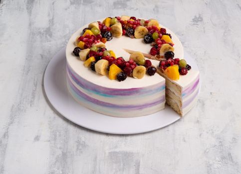 A top view shot of a fruit cake on a white plate