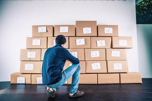 man in front of cardboard boxes