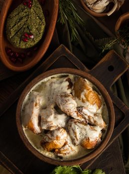 A top view of a chicken covered in a creamy sauce