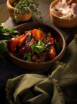 A vertical shot of a chef serving a gourmet salad dish