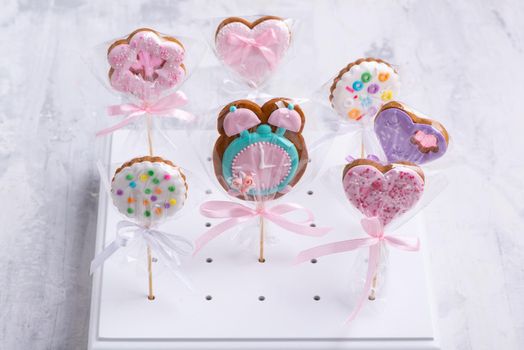 The set of colorful and sweet cookies on a stick